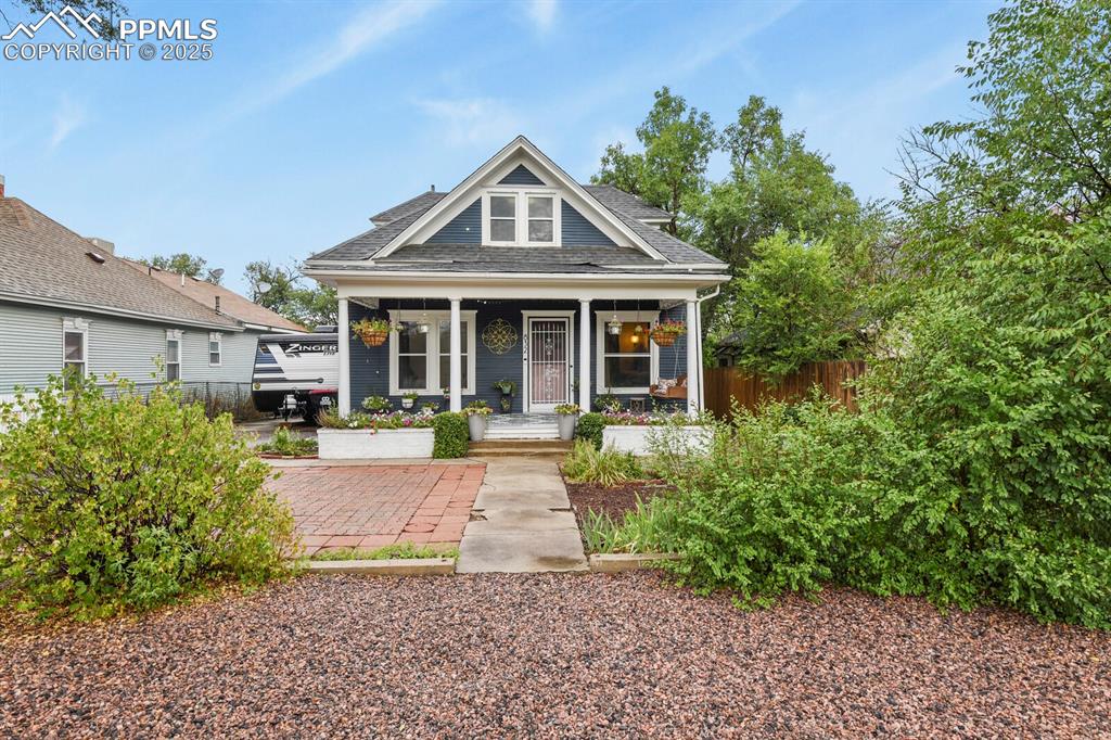 Image 2 of 36: Bungalow-style house with a porch and a shingled roof