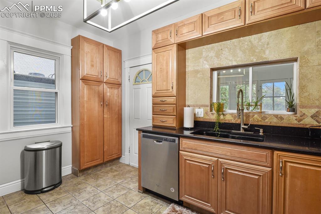 Image 20 of 36: Kitchen with healthy amount of natural light, stainless steel dishwasher, l