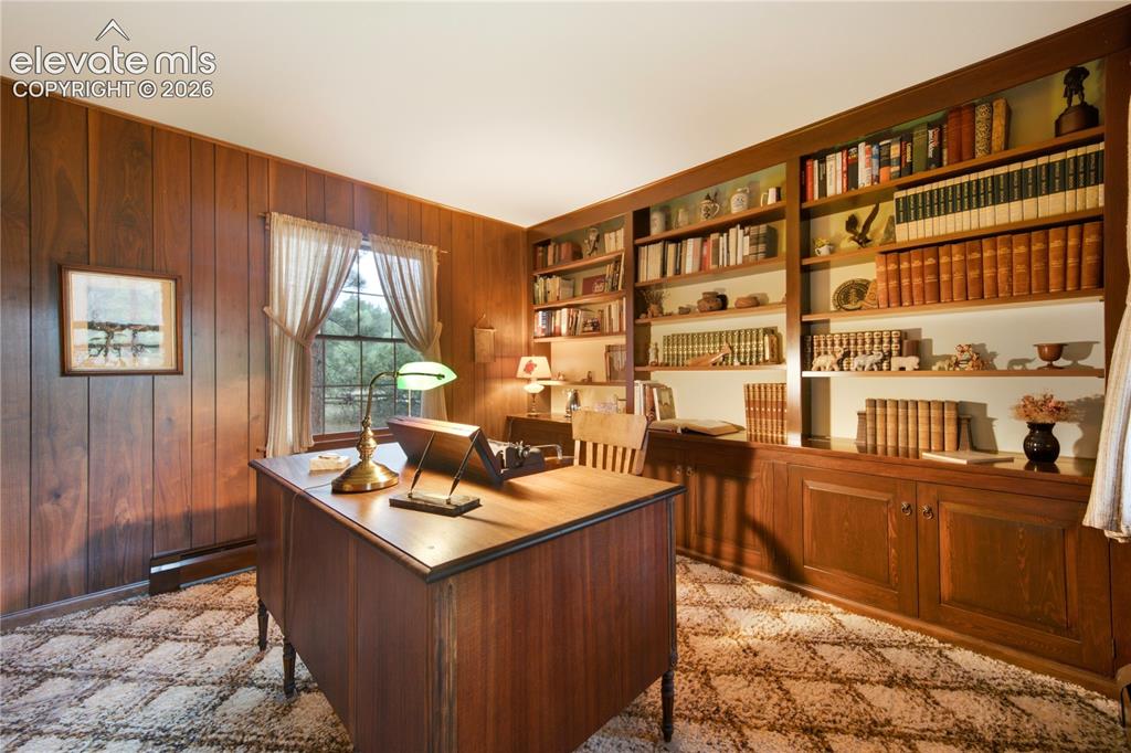Image 10 of 50: The formal dining room features elegant wainscoting and ample space for ent