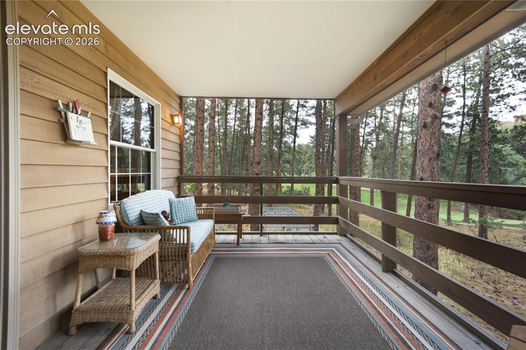 Image 13 of 50: A charming breakfast nook in the kitchen overlooks the natural wooded surro