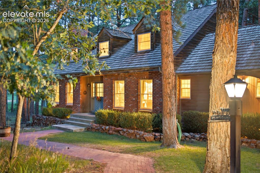 Image 2 of 50: Evening twilight illuminates the oversized two-car attached garage and the 