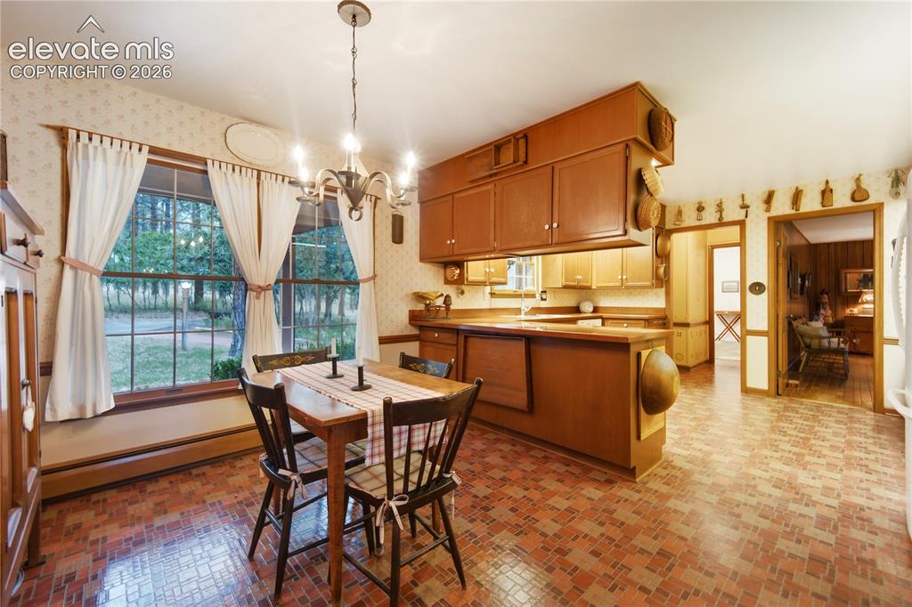Image 22 of 50: The screened, covered brick porch off the primary bedroom is an ideal spot 