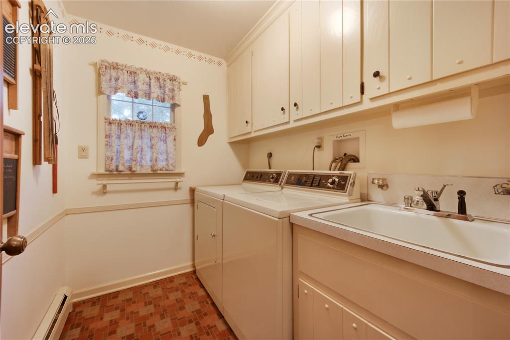 Image 24 of 50: The adjoining main-level primary bathroom provides convenience and classic 