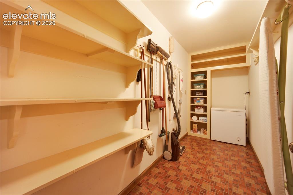 Image 25 of 50: A private study features handsome wood-paneled walls, built-in bookshelves,