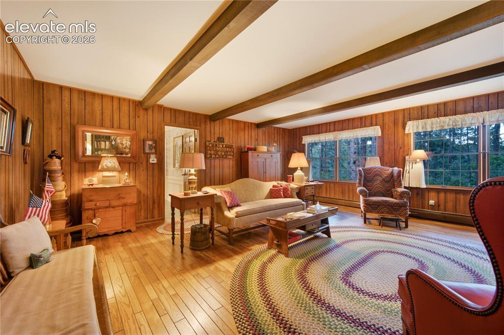 Image 26 of 50: Elegant double French doors connect the formal living room directly to the 