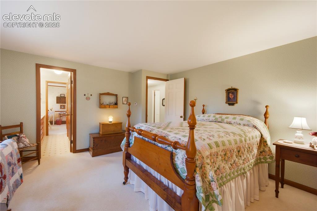 Image 36 of 50: Another view of the charming upstairs bedroom emphasizes its spacious layou