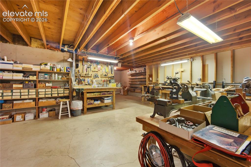 Image 40 of 50: Ample custom shelving lines the expansive basement, offering incredible sto