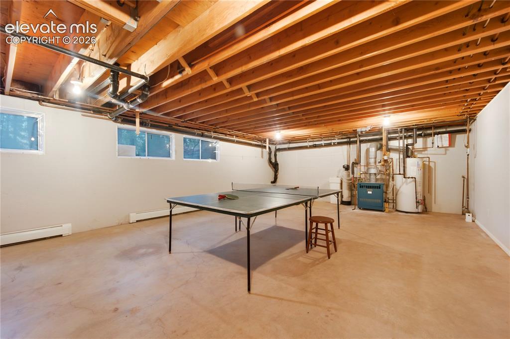 Image 41 of 50: The wide-open basement features magnetic insulating window covers and abund