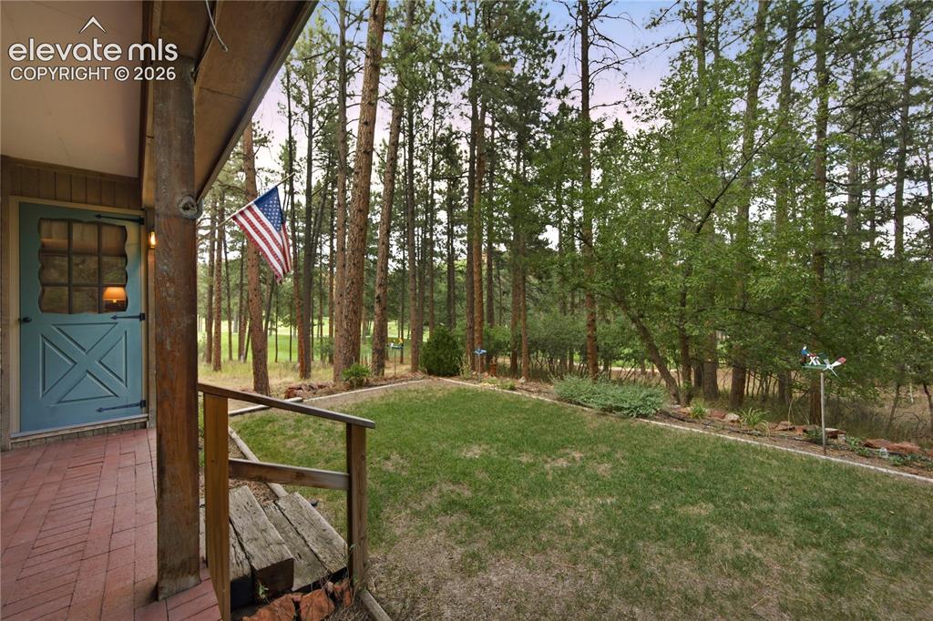 Image 45 of 50: This covered patio features lattice detailing and offers a shaded retreat r