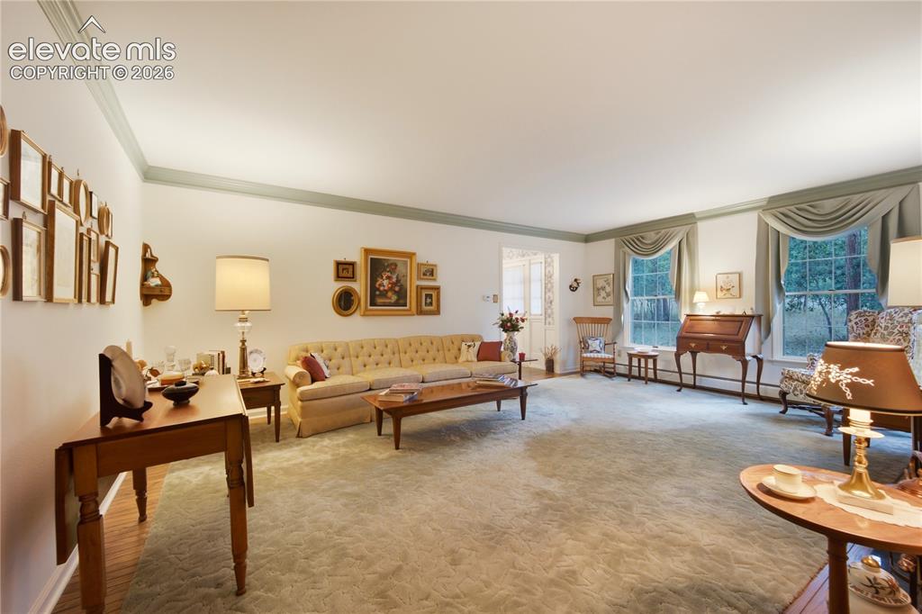 Image 9 of 50: The formal dining room boasts large windows and classic wainscoting, perfec