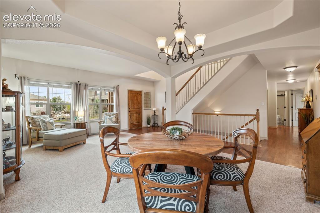 Image 10 of 50: Open-concept living area featuring a formal dining space with an overhead c