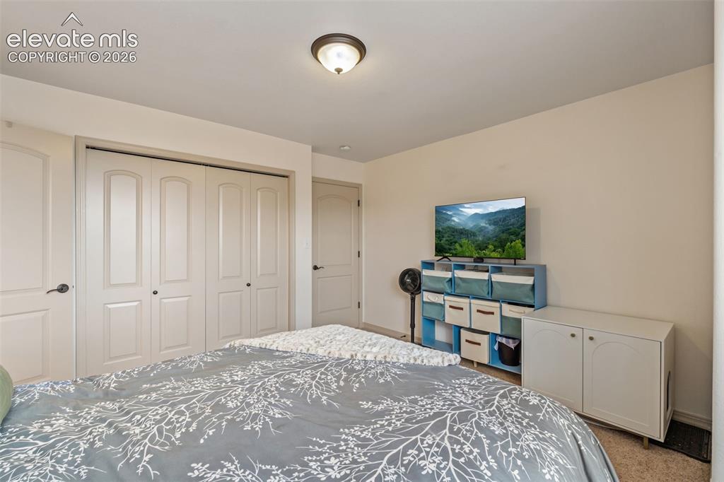 Image 35 of 50: Bedroom featuring a flush-mount ceiling light, light beige wall paint, and 