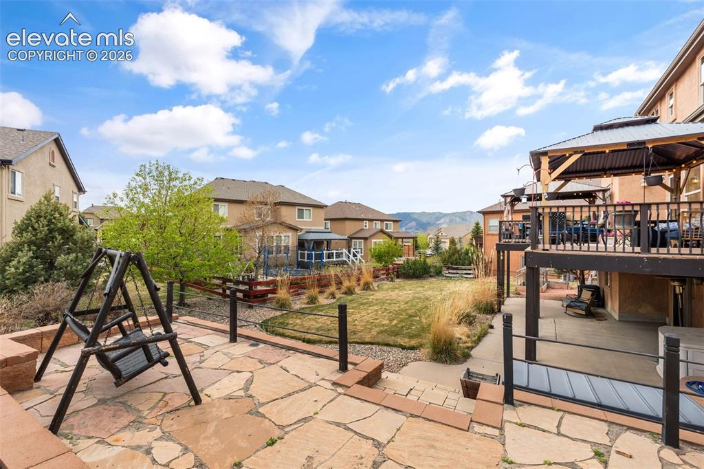 Image 42 of 50: Multi-level outdoor living space featuring a spacious flagstone patio, an u