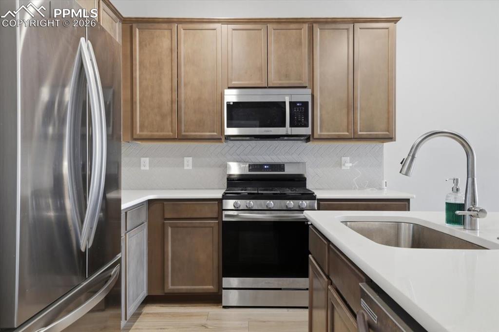 Image 12 of 40: Stainless steel appliances and quartz countertops.
