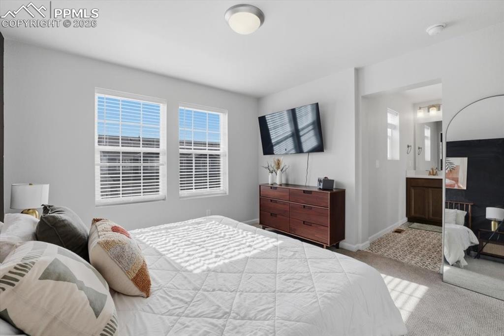 Image 25 of 40: Primary suite with attached bathroom.