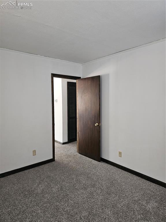 Image 7 of 13: Carpeted spare room featuring baseboards