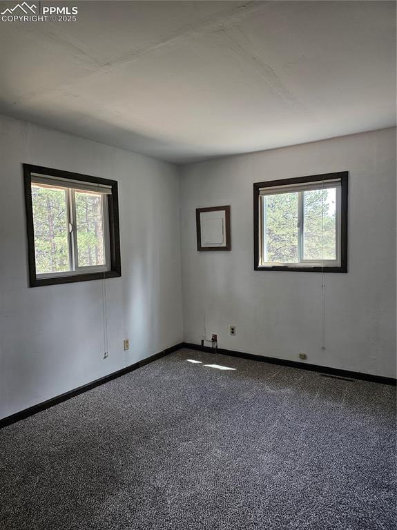 Image 8 of 13: Unfurnished room with baseboards and carpet flooring