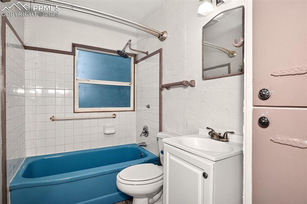 Image 10 of 12: Bathroom featuring vanity, shower / washtub combination, and a textured wal