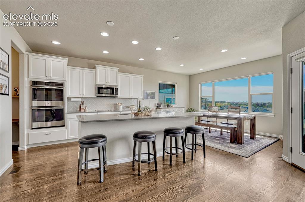 Image 13 of 50: Equipped with premium double ovens and a spacious pantry, this professional