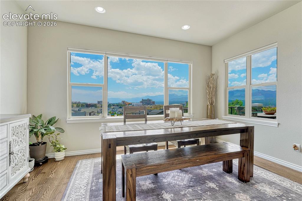 Image 15 of 50: The sun-drenched dining area features expansive windows that perfectly fram