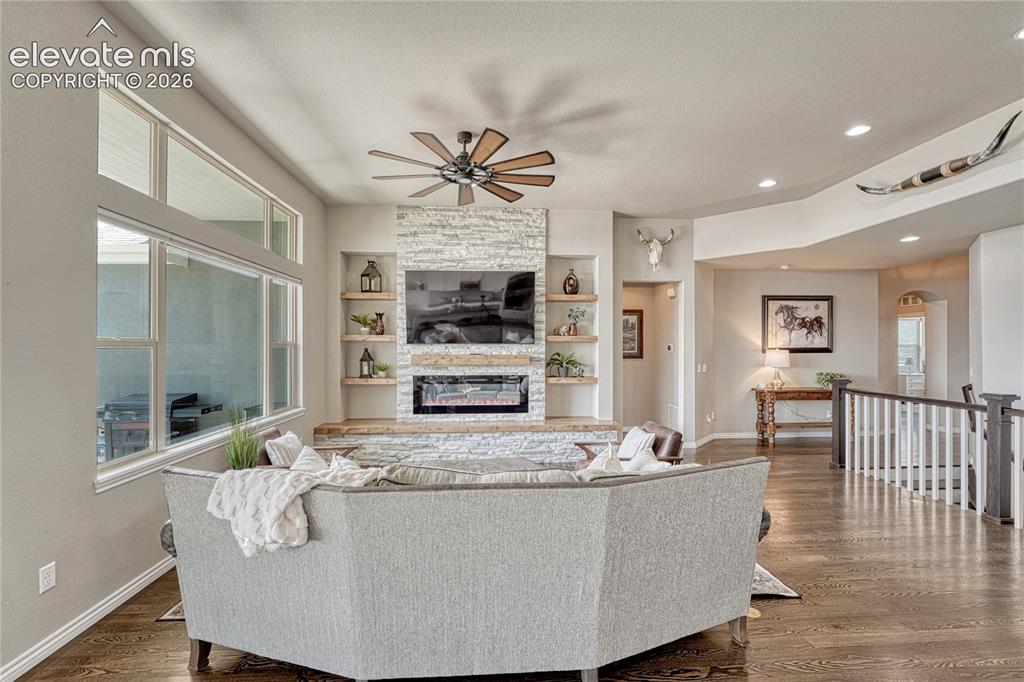 Image 19 of 50: The cozy main-level family room features a sleek electric fireplace built i