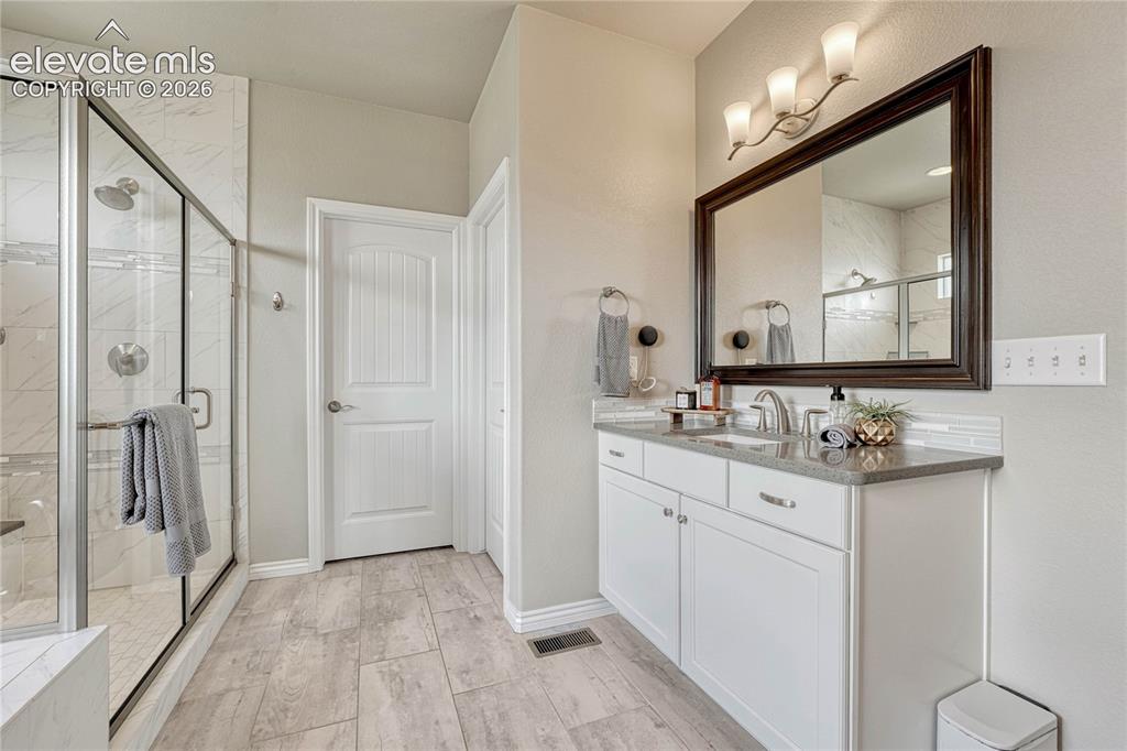 Image 23 of 50: Another view of the primary bathroom highlights the exquisite tile craftsma