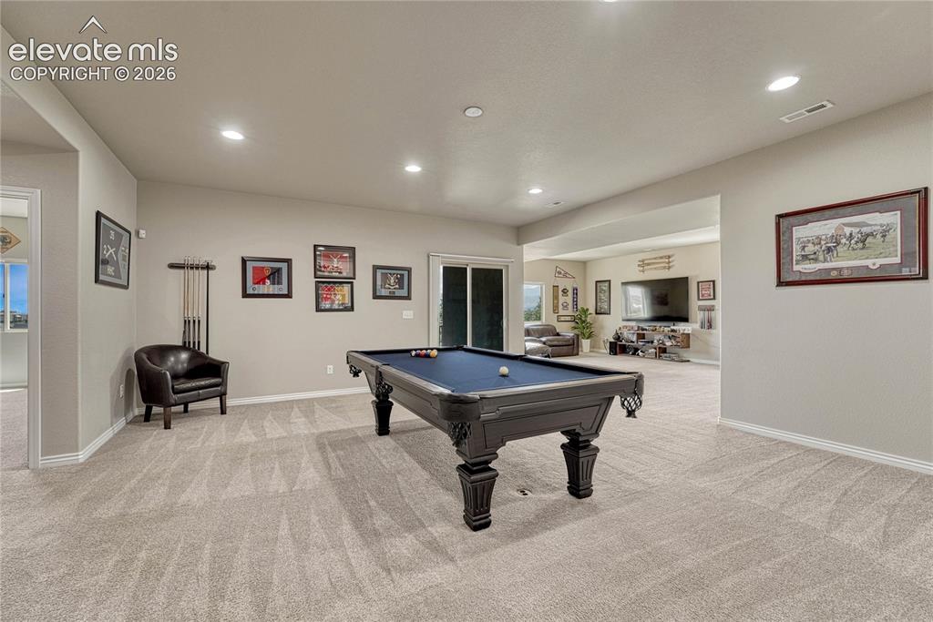 Image 26 of 50: The expansive basement recreation room offers plenty of open space for a fu