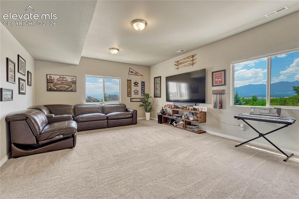 Image 29 of 50: Large basement windows flood the lower-level living area with exceptional n