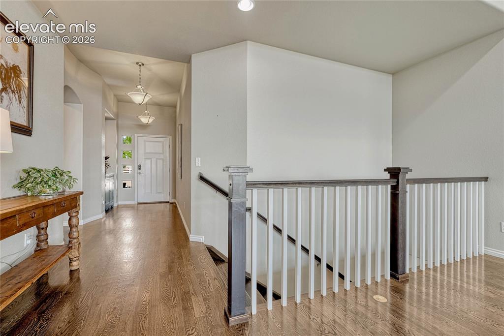 Image 3 of 50: Stepping inside, the bright foyer showcases gorgeous oak hardwood floors an