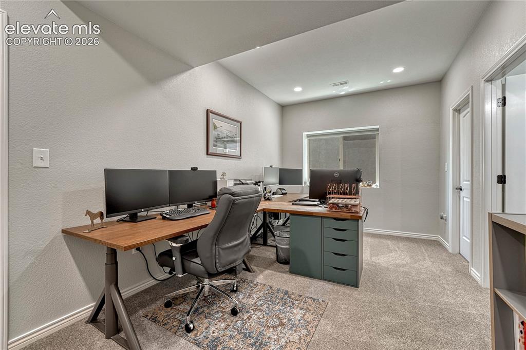 Image 31 of 50: The basement includes a newly finished secondary office or multi-purpose wo
