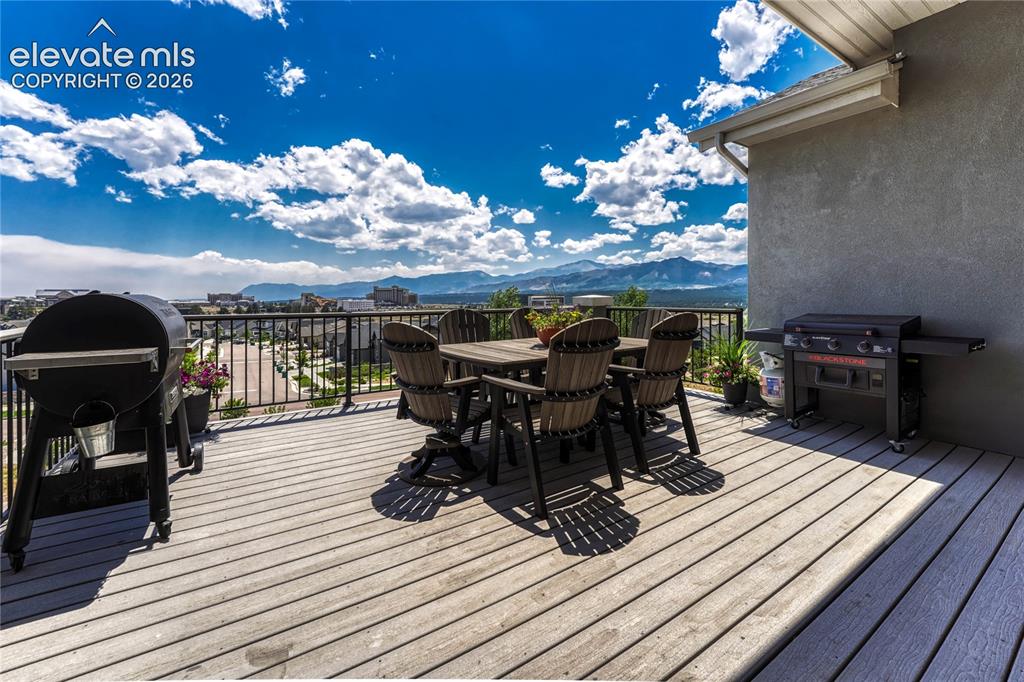 Image 40 of 50: Step out onto the expansive covered composite deck, fully equipped with a g