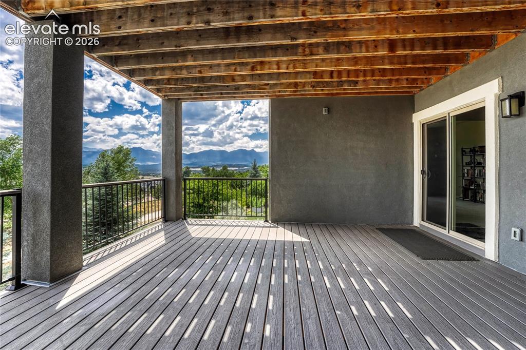 Image 42 of 50: The shaded lower-level covered patio provides a cool, private outdoor escap