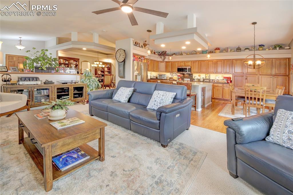 Image 11 of 50: Living room has ceiling fan