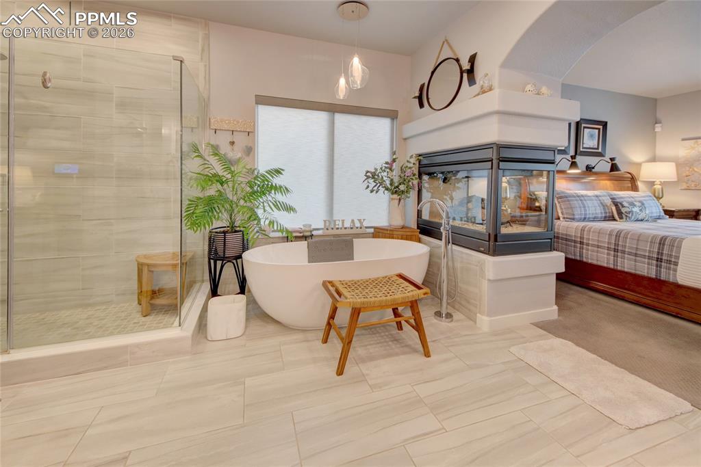 Image 18 of 50: Master suite 2 sided gas fireplace