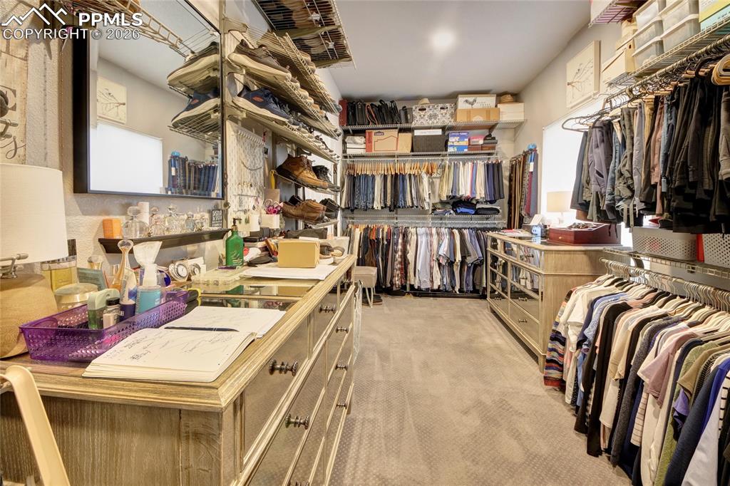 Image 21 of 50: Master suite walk in closet that connects to the laundry room