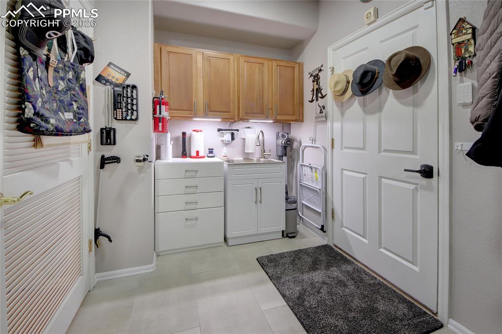 Image 23 of 50: Laundry room with sink and next to garage
