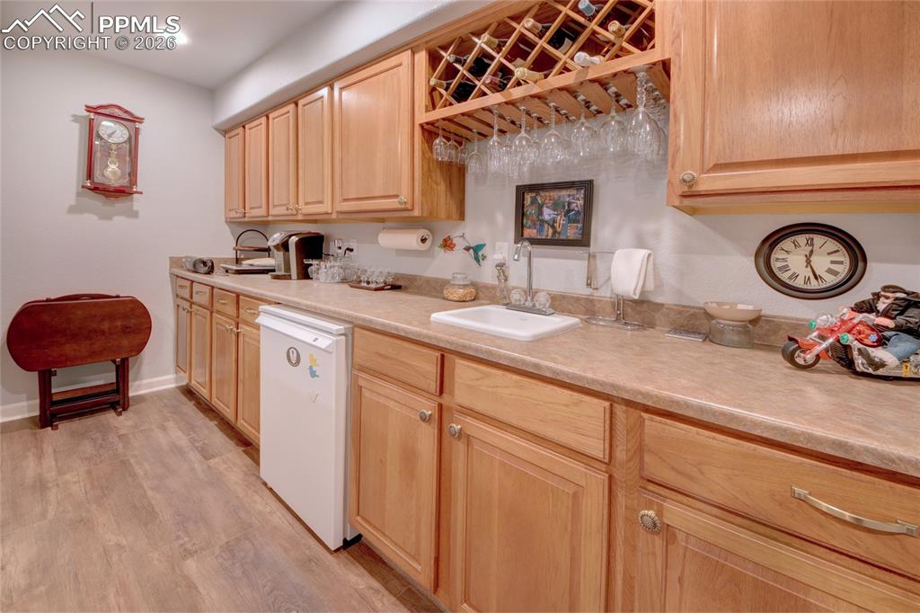 Image 30 of 50: Family room wet bar and refrigerator