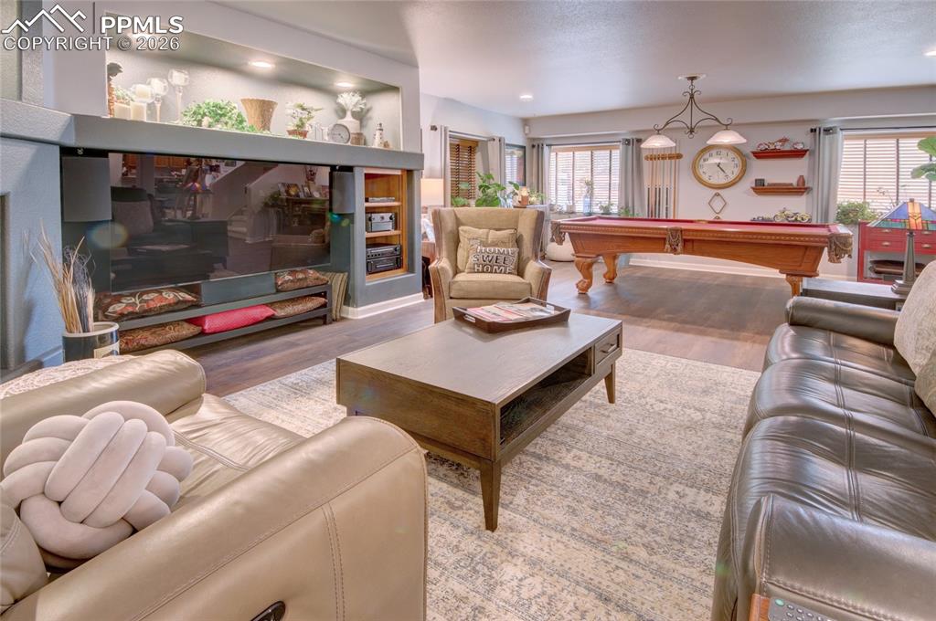 Image 30 of 50: Family room entertainment center and gas fireplace