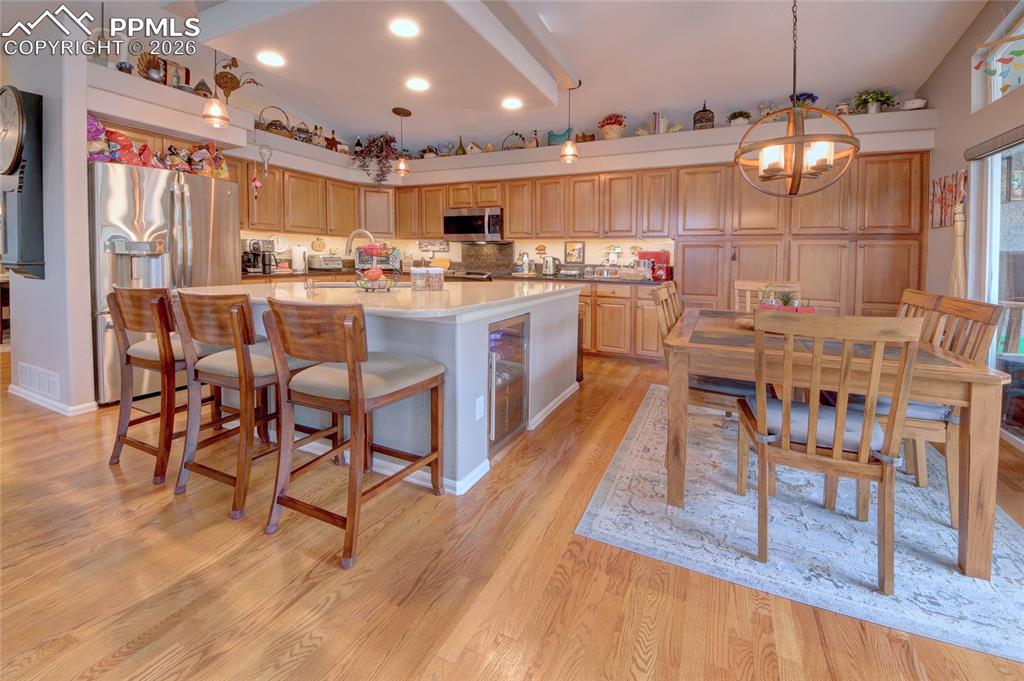 Image 4 of 50: Kitchen pendent lighting and beverage cooler