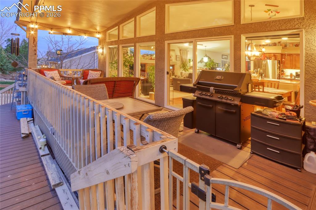 Image 45 of 50: Covered rear deck at twilight