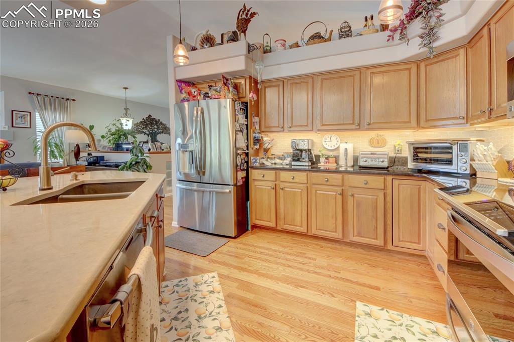 Image 6 of 50: Kitchen stainless steel appliances and subway tile backsplash