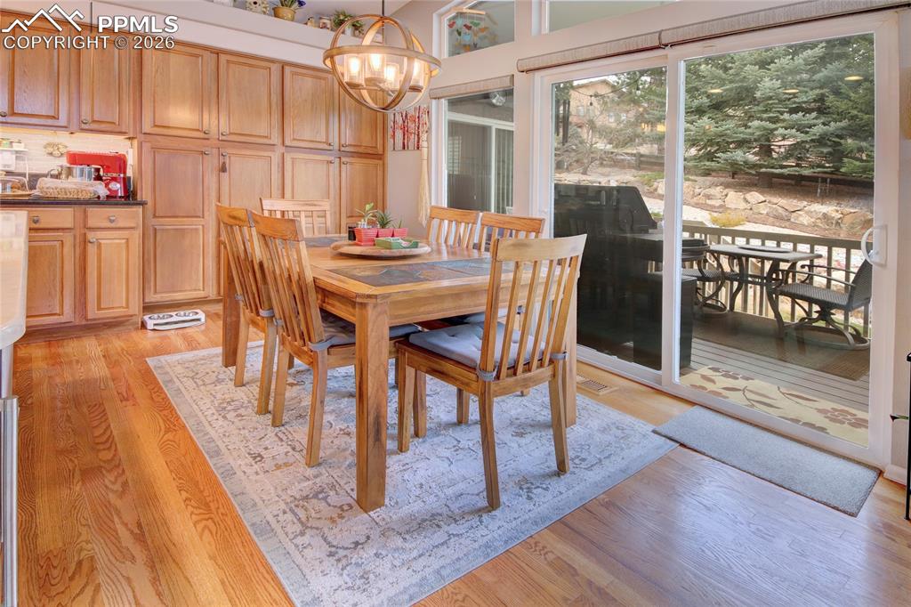 Image 8 of 50: Kitchen breakfast area, built in pantry, and walk out to trex deck