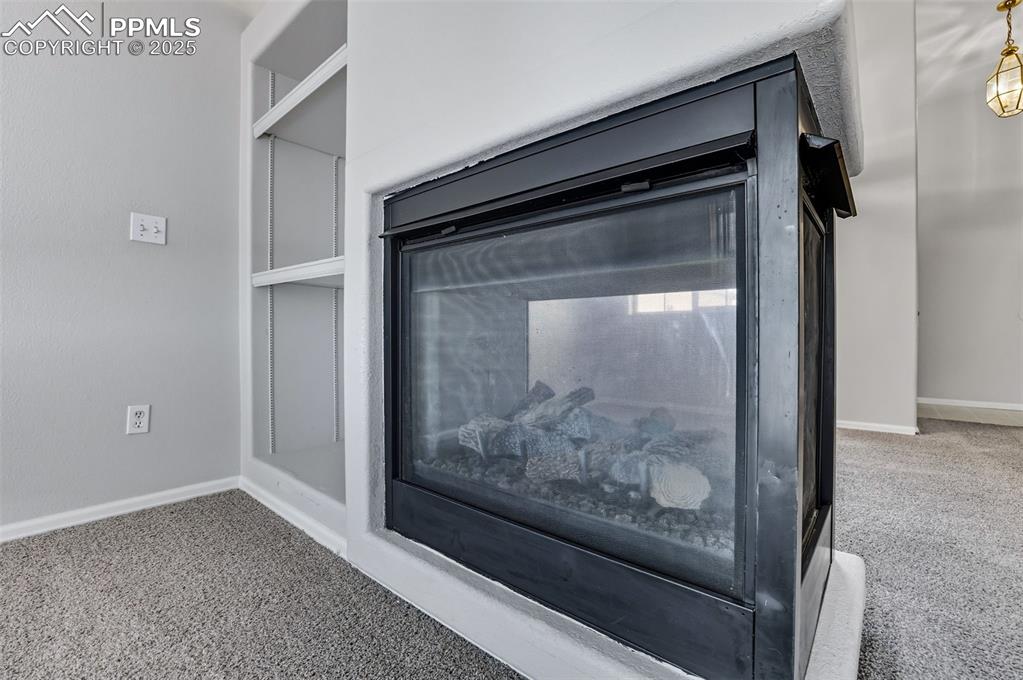 Image 19 of 47: Great room with built ins and 3 sided gas fireplace