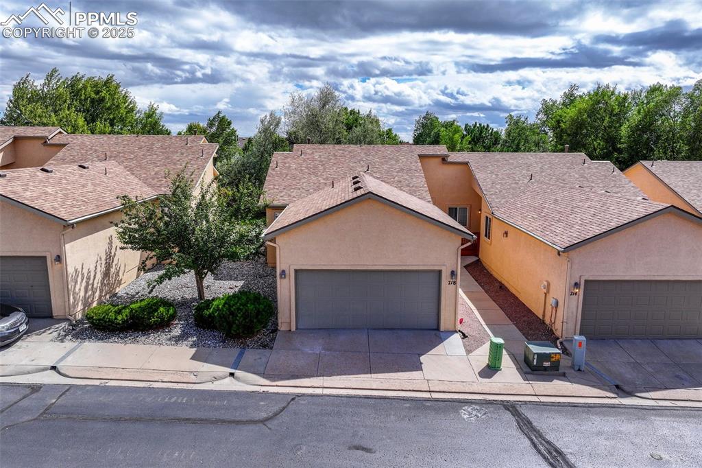 Image 2 of 47: View of front of house featuring driveway, stucco siding, an attached garag