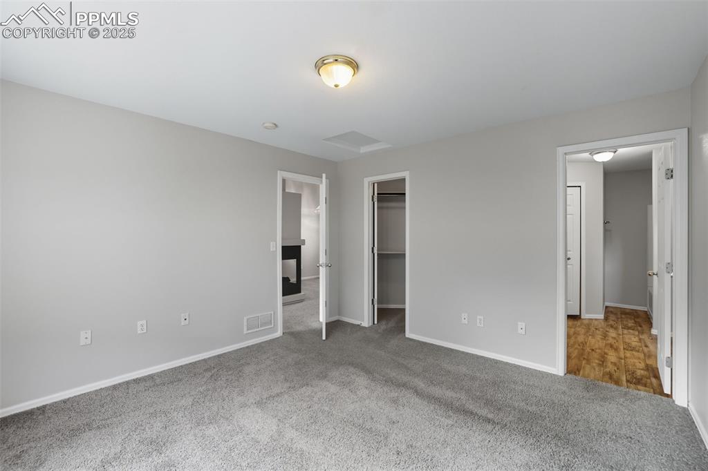 Image 24 of 47: Walk in closet & adjoining 4 pc master bathroom