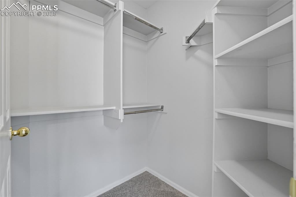 Image 29 of 47: Spacious walk in closet in master bedroom