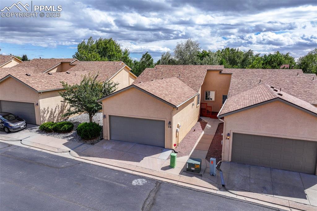 Image 3 of 47: Ranch-style house featuring stucco siding, driveway, an attached garage, an