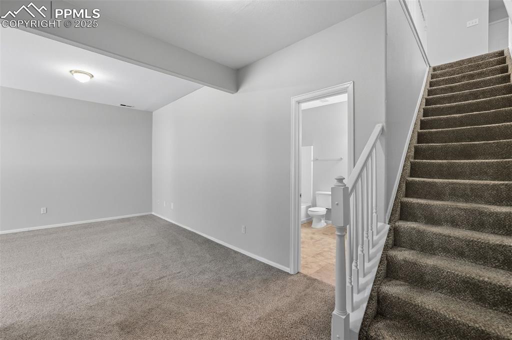 Image 35 of 47: Stairs to basement family room