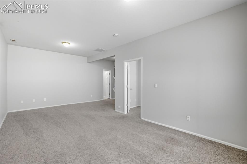 Image 38 of 47: Unfurnished room with carpet floors and baseboards