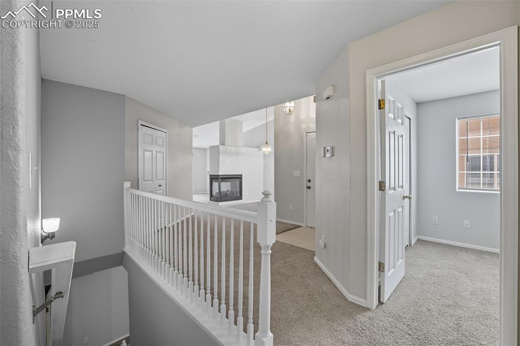 Image 8 of 47: Hallway to basement stairs, 2nd main level bedroom, formal living room & fo